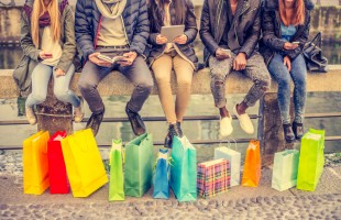 Group of friends sitting outdoors with shopping bags - Several people holding smartphones and tablets - Concepts about lifestyle,shopping,technology and friendship